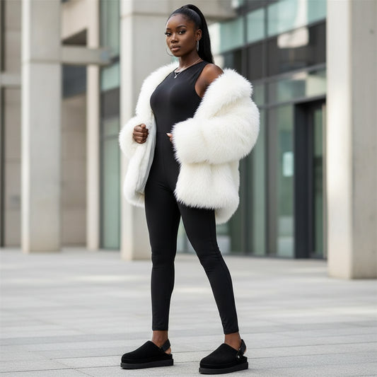 Black woman wearing black slip-on  shoes with white fur outside a building